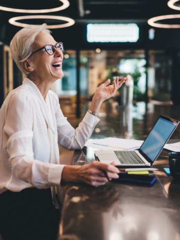 happy-businesswoman-laughing-while-working-on-lapt-2023-05-25-16-12-02-utc-scaled.jpg